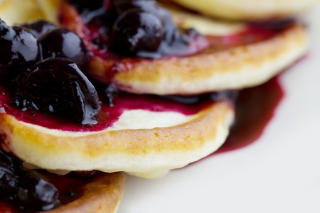 pancakes with blackcurrant jam on a white background