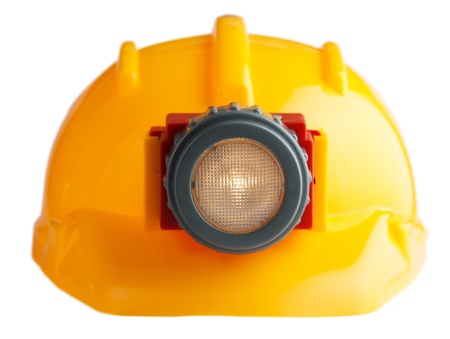 construction helmet with a flashlight on a white backgoundの写真素材