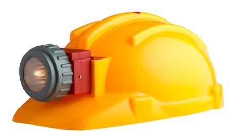 construction helmet with a flashlight on a white backgoundの写真素材