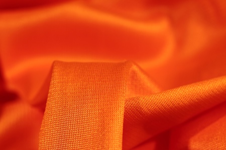 background of orange fabric closeupの写真素材