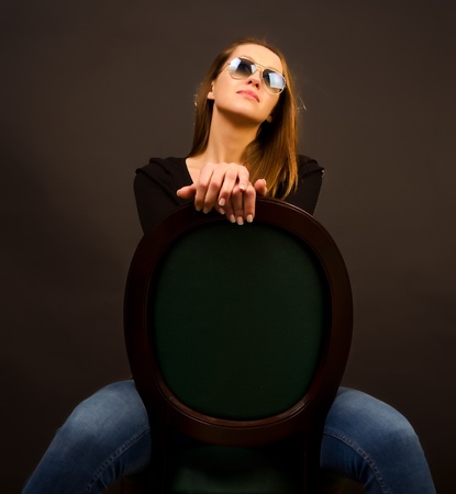sexy girl sitting on a chairの写真素材