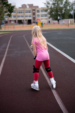 active lifestyle in a modern city - active lifestyle in a modern city - stylish girl roller-blading in a stadiumの写真素材