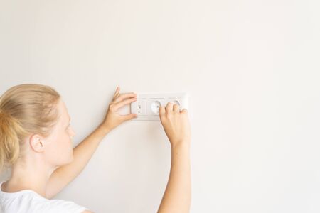 non-female work. repair and decoration. woman repairs outlets in a new apartmentの写真素材