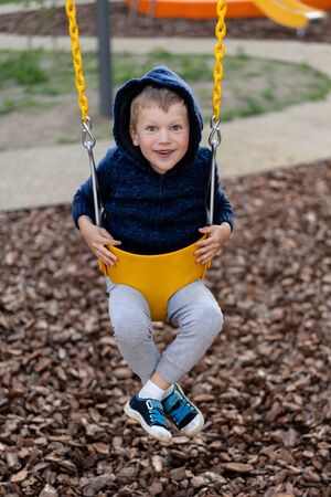 a little boy is having fun playing on the modern urban European playgroundの写真素材