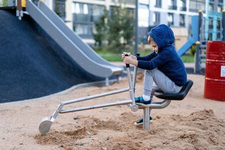 a little boy is having fun playing on the modern urban European playground