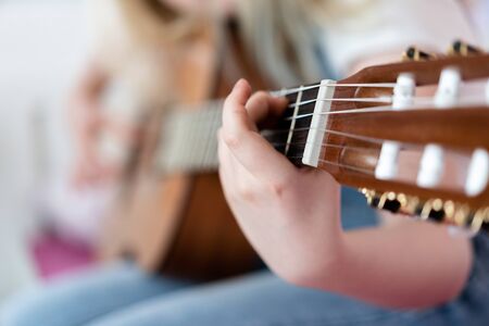 Generation Z - a teenager girl plays the guitar in her room