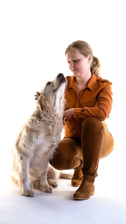 love for pets. studio portrait of a woman and golden retriever in studio on a white background.の写真素材