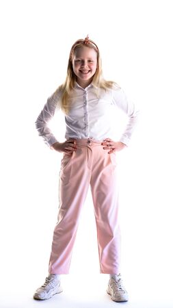 portrait of a cheerful schoolgirl girl on a white background in studioの写真素材
