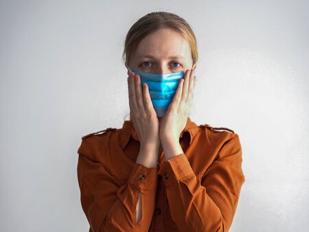 protection against coronavirus. woman puts a mask on her face.