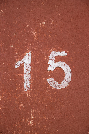 Print number fifteen is written in white on a red wall