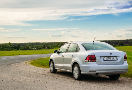 Gomel, Belarus - June 13, 2016: Volkswagen Polo car parked on the side of the road against the sky and the countrysideのeditorial素材