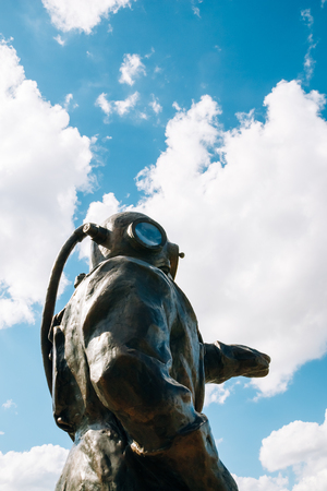 Moscow, Russia - August 17, 2016: Bronze sculpture Diver- lighthouse on a background of beautiful blue sky with cloudsのeditorial素材