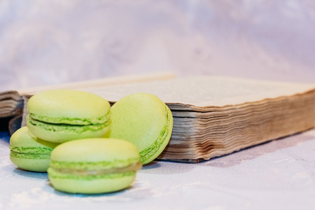 Four French macarons on a background of an old bookの写真素材