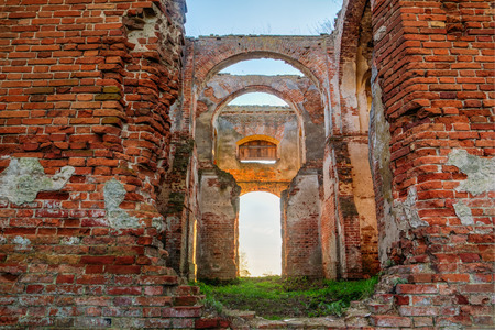 Wall of red bricks and ruined a corridor of the old Orthodox church in the village of Lenino, Dobrush district, Gomel region, Belarusの写真素材