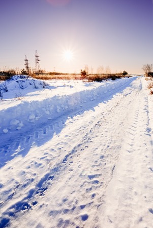Rural road in winter at sunsetの写真素材
