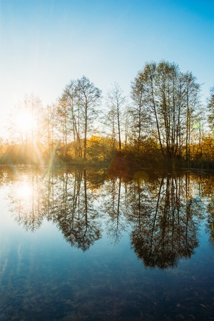 Landscape with sunset and reflections in the waterの写真素材