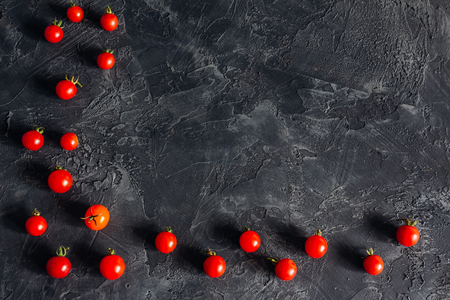 Dark background with cherry tomatoes and copy spaceの写真素材