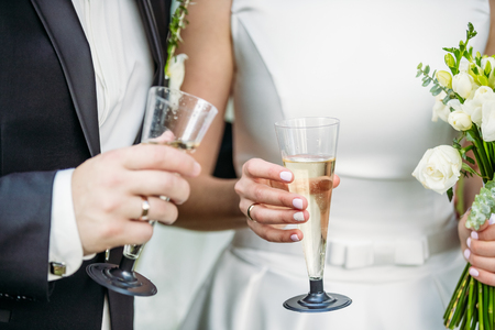 Newlyweds with champagne in their handsの写真素材