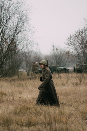 Soldier of the USSR in a greatcoat in the field. Gomel, Belarusのeditorial素材