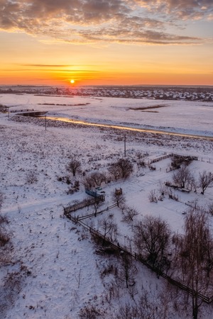 Beautiful dawn in the winter morning over the fieldの写真素材