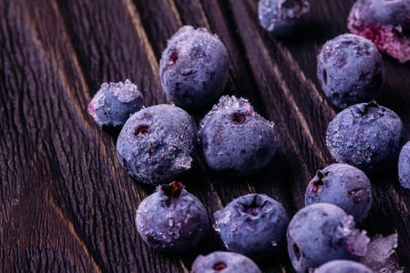 Blueberries frozen on a wooden backgroundの写真素材