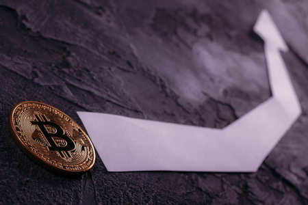 Coin bitcoin BTC close-up with an arrow pointing upwardsの写真素材