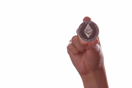 Ethereum ETH cryptocurrency coin in his hand