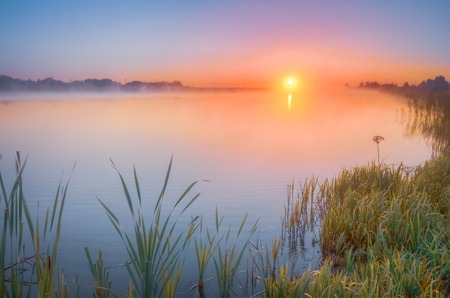Autumn sunrise over the lakeの写真素材