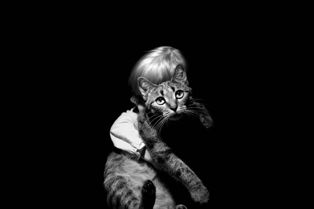 Baby hugging his cat on black and whiteの写真素材