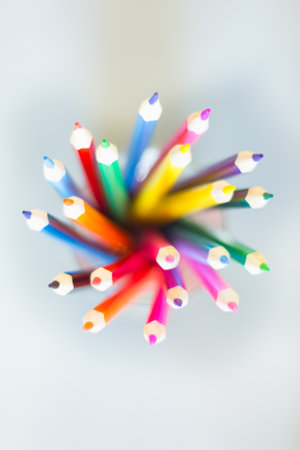 Color pencils fan in a glass on a white backgroundの写真素材