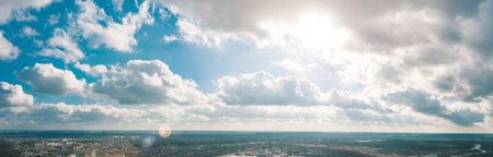 A stunning sky landscape with bright sunlight and fluffy clouds creating a captivating viewの写真素材