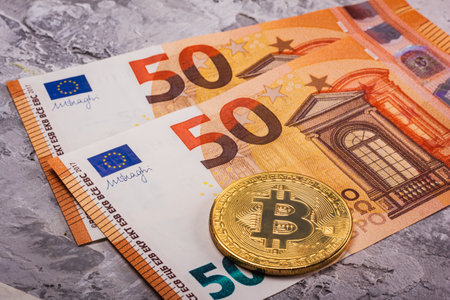 Euro Banknotes and Bitcoin Coin symbolize the significant evolution of digital currency and modern financeの写真素材