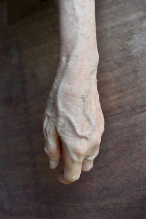 Southeast Asian, Myanmar old womanâs hand. Skin creases, loosen skin and veins show aging.の写真素材