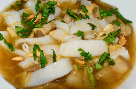 Myanmar homemade Lor Mee recipe. Lor mee is a Chinese, Indonesian or Malaysian noodle dish served in thick starchy gravy and flat yellow noodles. Closeup view.の写真素材