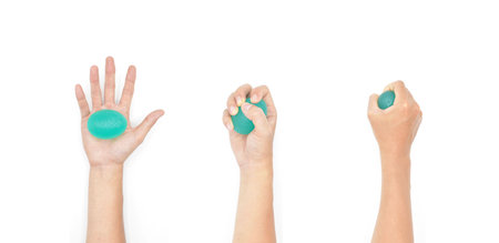 Hand Exercise Round Ball, Hand Grip Squeeze Ball for Strength, Stress and Recovery. Home light workout by man. Isolated on white.の写真素材