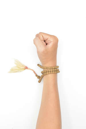 Arm wearing Buddhist prayer beads. Master of Chinese martial arts. Isolated on white.の写真素材