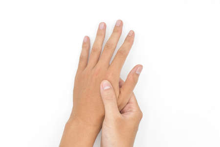 Self hand massage by Asian young man. Fingers and hand joint health. Isolated on white.の写真素材