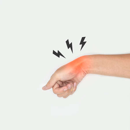 Inflammation of Asian young manâs wrist joint and hand. Concept of joint pain and tendonitis.の写真素材