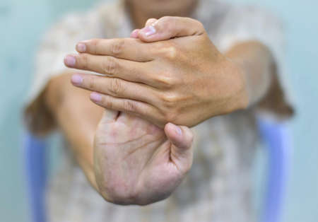 Strengthening exercise for arm muscles of Asian young male patient with muscle spasm.の写真素材