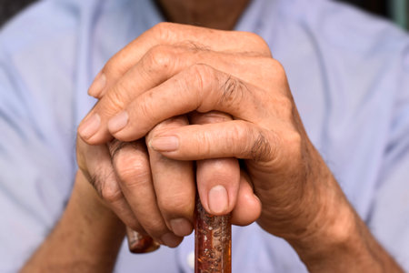 Hand of Southeast Asian elder man. Concept of rheumatoid arthritis, osteoarthritis, or joint pain.の写真素材