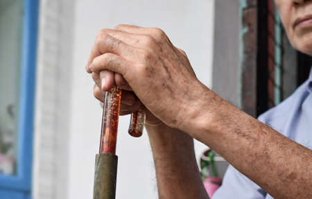 Hand of Southeast Asian elder man. Concept of rheumatoid arthritis, osteoarthritis, or joint pain.の写真素材