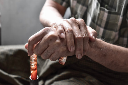 Hands of Southeast Asian elder man. Concept of rheumatoid arthritis, osteoarthritis, or joint pain.の写真素材