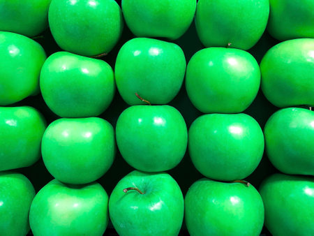 Green apples called granny smith arranged in stack for sale. Green apples pattern. Close up view....