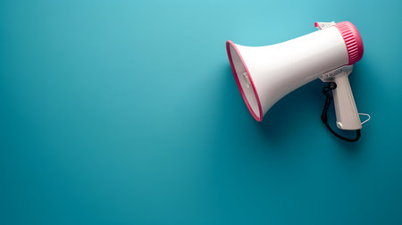 Megaphone or hand speaker isolated on blue color background with copy spaceの素材
