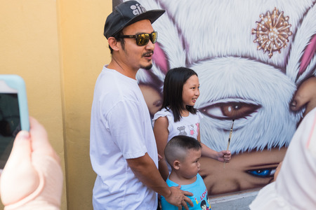 Portrait of Alex Face with people . a famous Thai street artist and graffiti with his mural artwork of an iconic character 'Mardi'のeditorial素材