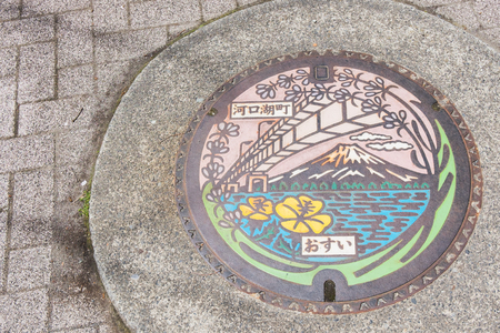 Mt. Fuji, bridge and the lake on manhole cover of Kawaguchiko lake in Yamanashi, Japan.の写真素材
