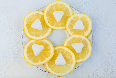 Fresh lemon with sugar on a white plateの写真素材
