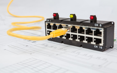 Network switch and UTP ethernet cable on the blueprint of communication equipment