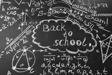 Back to school background with title Back to school and formulas written by white chalk on the...