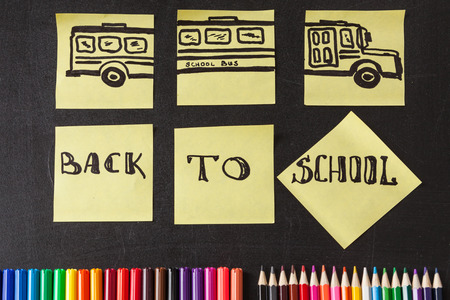 Back to school background with a lot of colorful felt-tip pens and colorful pencils, titles Back to...